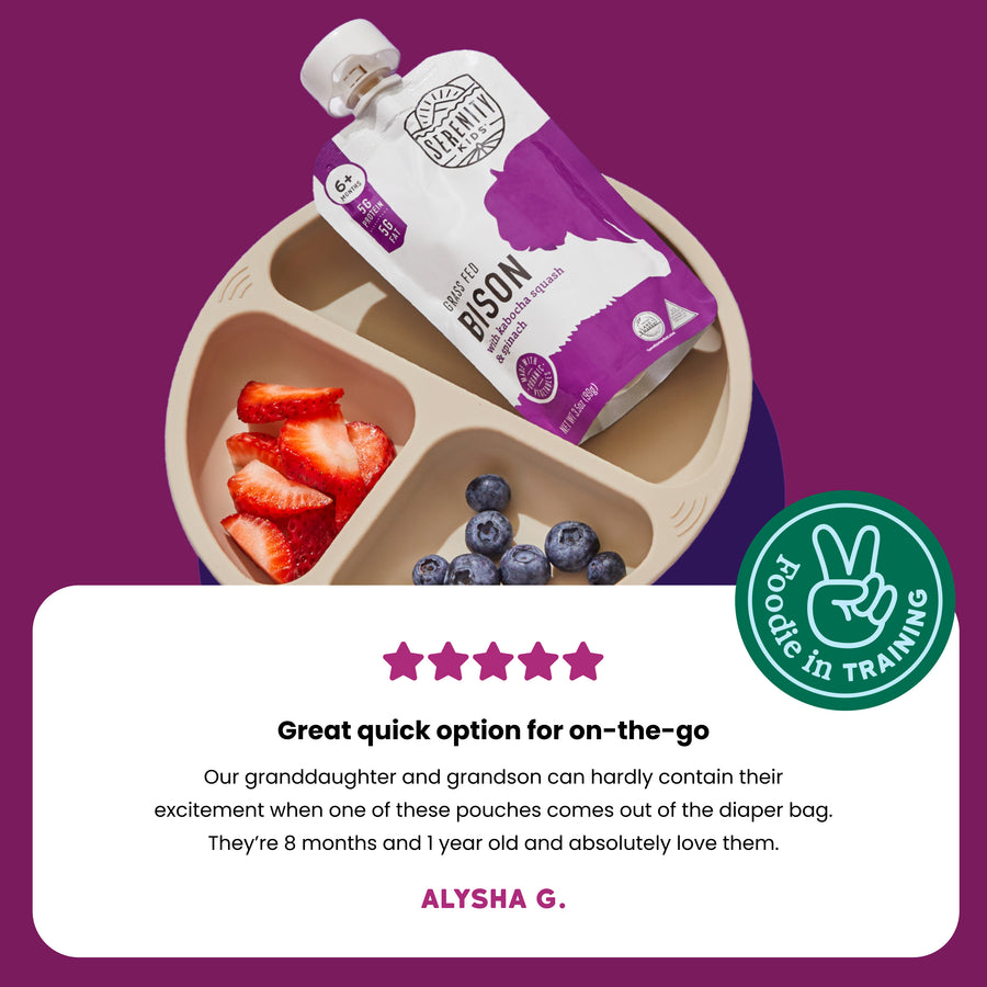 Bison meat pouch with berries on a divided plate against a purple background