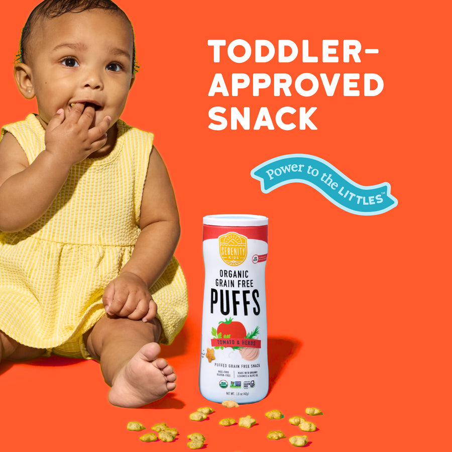 Child in a yellow outfit with a container of Puffs snacks on an orange background